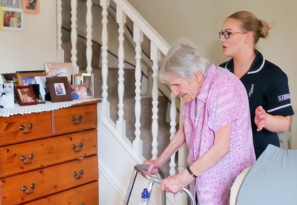 Carer-with-lady-on-walking-frame